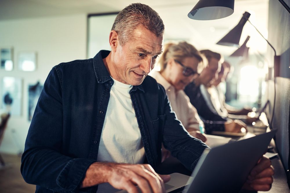 Man concentrating while working on his laptop