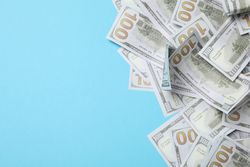 American cash money on blue background, space for text