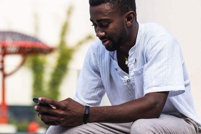 Black man using smartphone in city