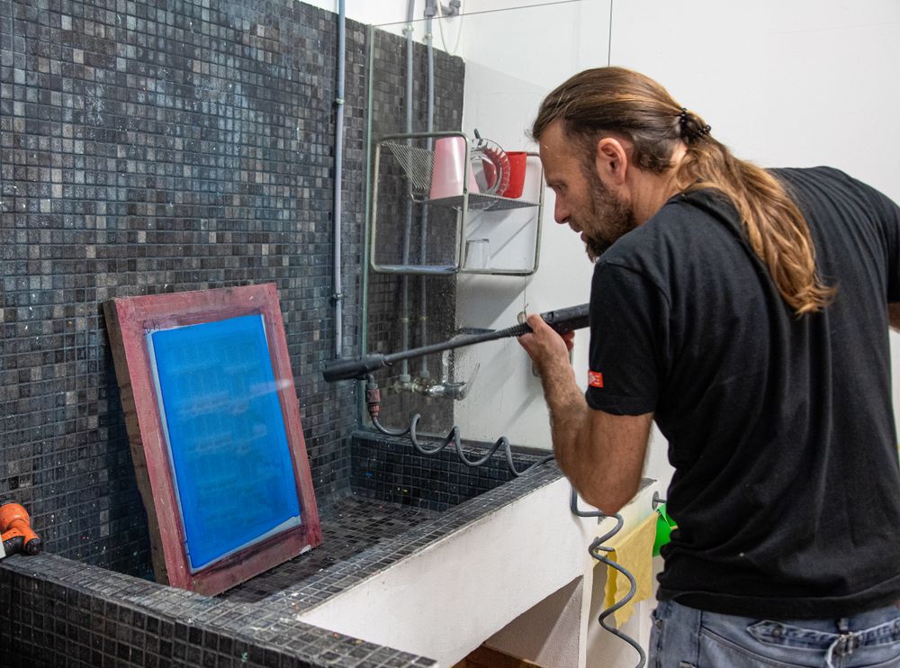 Artist preparing silkscreen for serigraphy