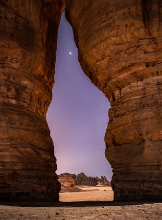 Gate rock formation showcasing Venus in clear desert sky