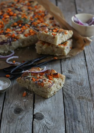 Pieces of fresh focaccia on wooden table
