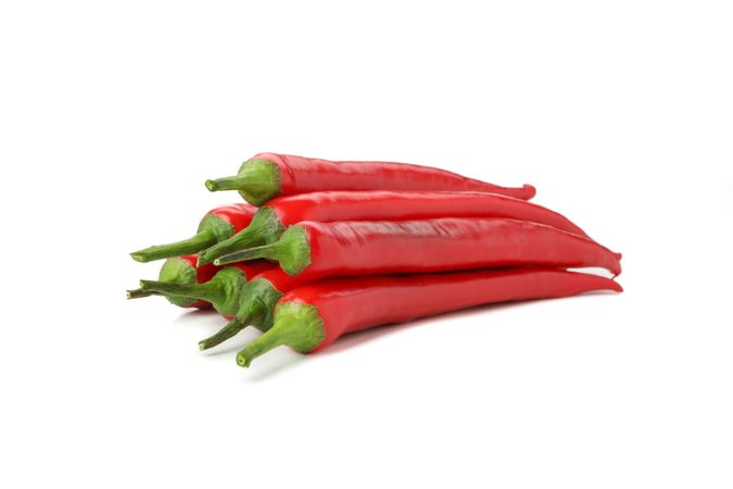 Tasty red chilli peppers isolated on blank background