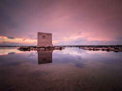 Wonderful watchtower in calm lake on cloudy day