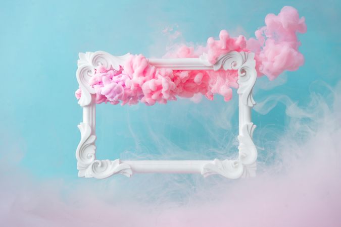 Cloud-like pink color paint with  light picture frame on blue background