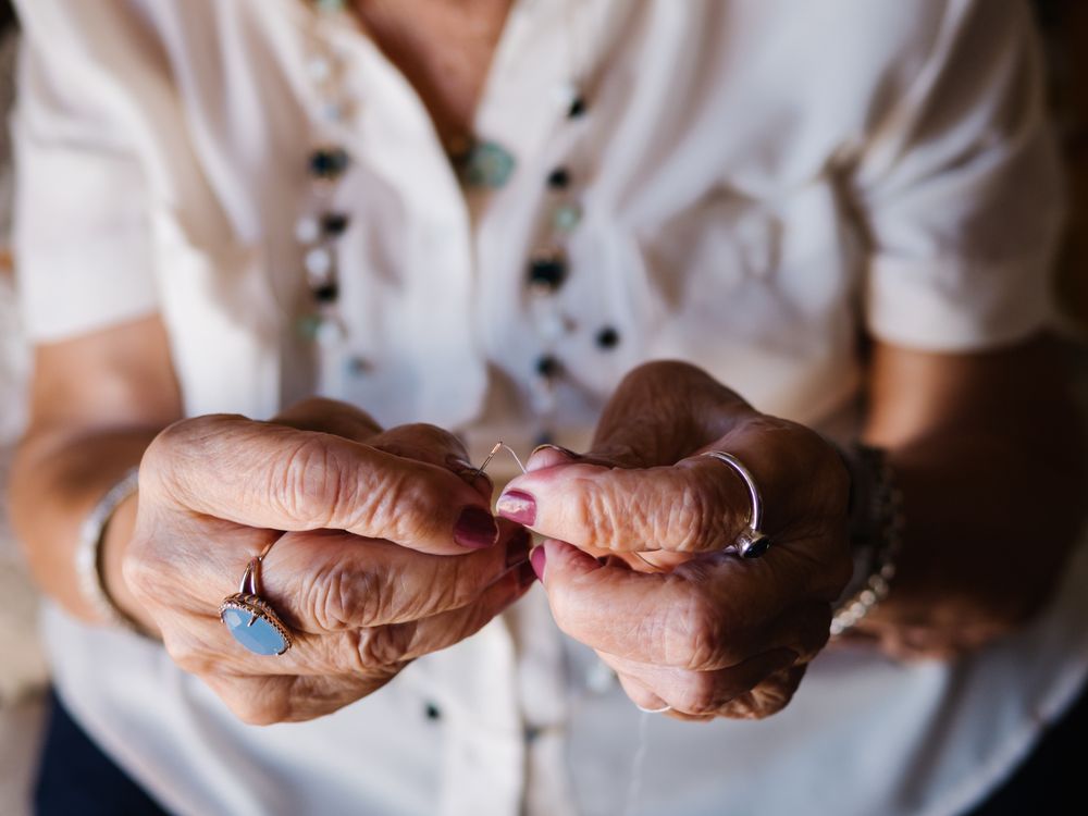 Older woman with threads sitting at home