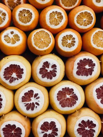 Cut oranges and grapefruits in rows at outdoor market