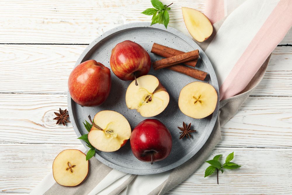 Looking down at plate of apples, anise and cinnamon sticks