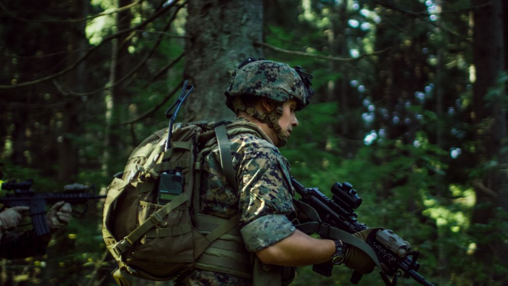 Fully Equipped Soldiers Wearing Camouflage Uniform Attacking Enemy, Rifles in Firing Position.