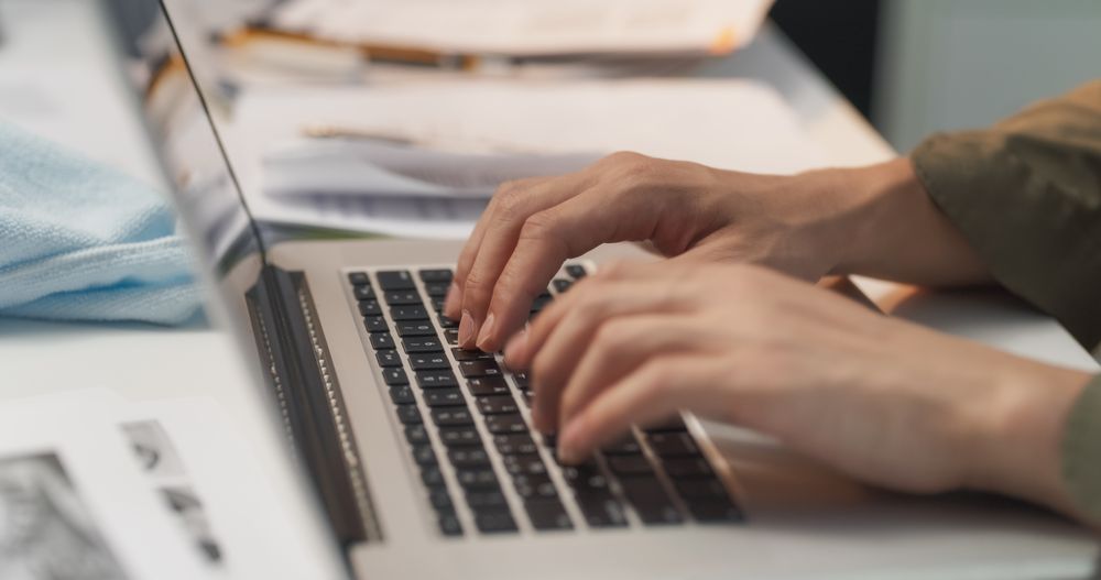 Close Up of Strategic Planning Specialist's Hands Typing on a Laptop Computer