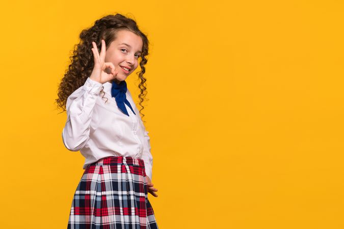 Girl making OK gesture with hand