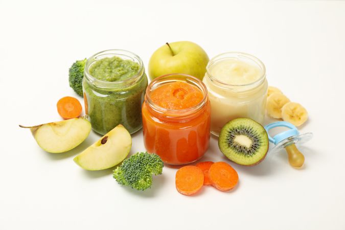 Composition with baby food on plain background. Vegetable puree