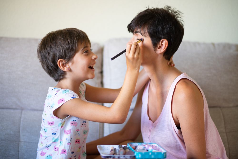 Little girl putting eye shadow on her