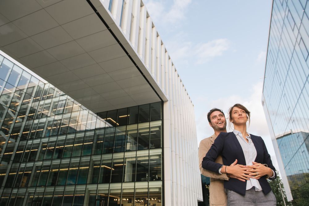 Businesspeople couple outside contemporary building