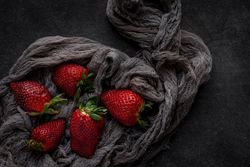 Red and fresh strawberries flat lay in a piece of cloth