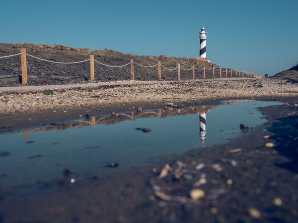 Sidewalk leading to lighthouse in countryside