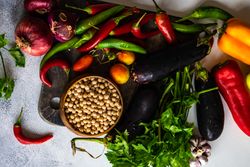 Fresh vegetables and legumes on wooden board with copy space