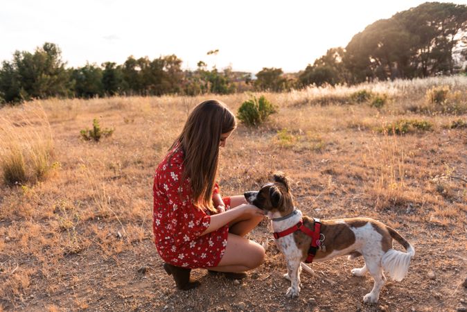 Woman with small friendly dog outdoors