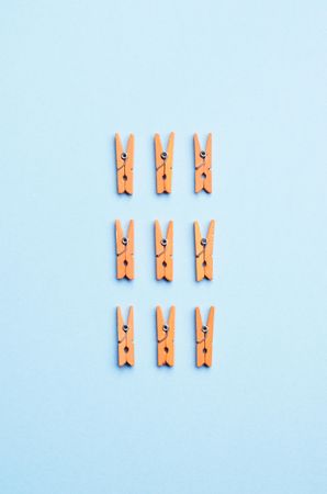 Clothes pins on light blue background