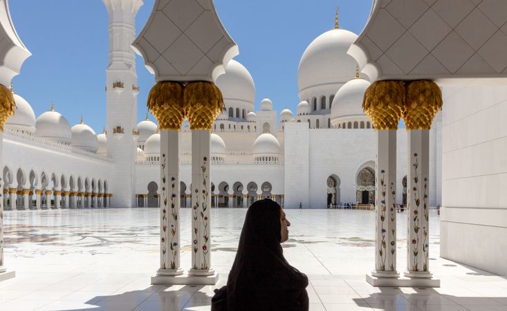 United Arab Emirates - May, 25 2013: Muslim woman in mosque courtyard