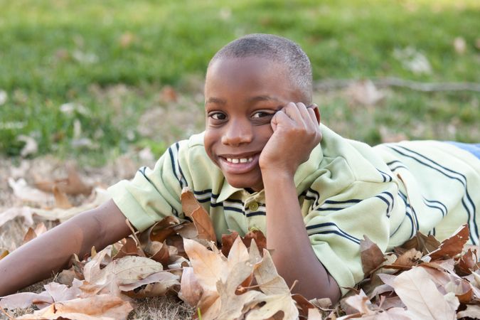 Young Boy Smiling While Playing in the Park