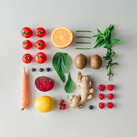 Neatly arranged fruits, vegetables and herbs on bright  table background