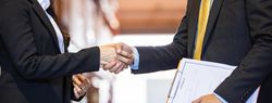 Banner of the hands of two male and female colleagues shaking hands