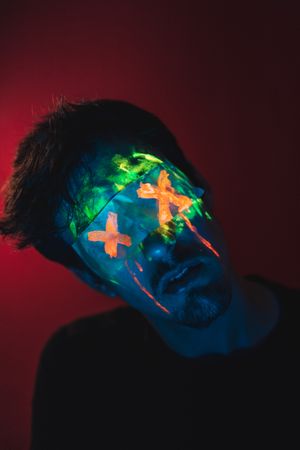 Male with covered eyes and neon face