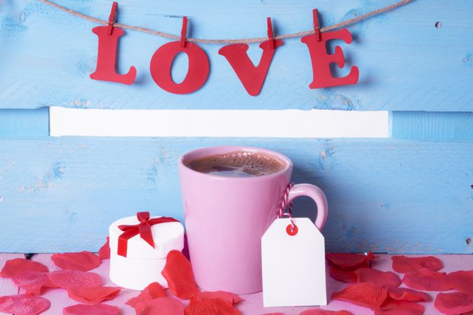Coffee cup with a gift and the word love