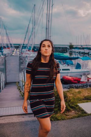 Smiling female walking along busy urban pier