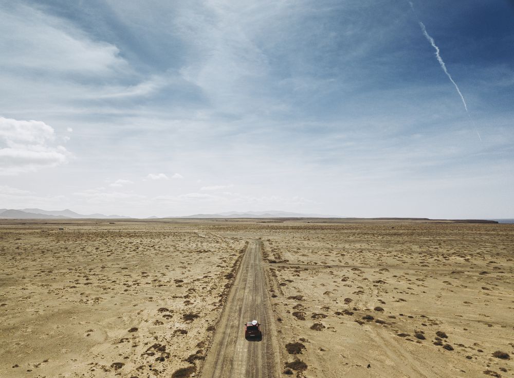 Car driving on road in picturesque desert