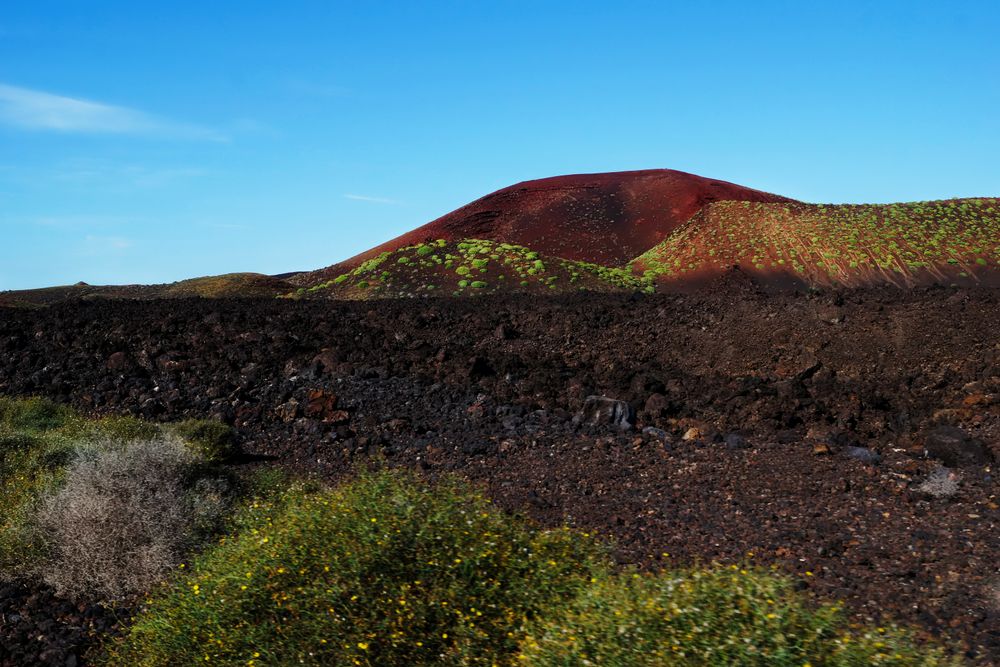 Picturesque view of volcanic terrain with solidified lava in wild area
