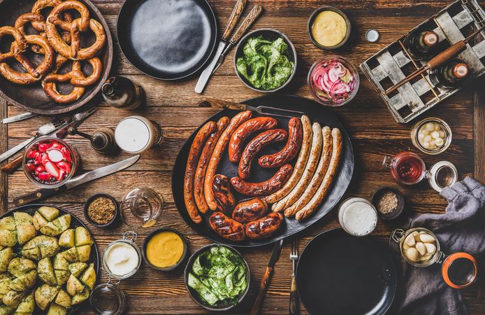 German sausages and pretzels displayed on wooden table