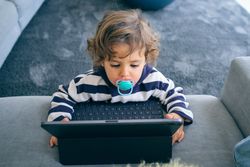 Little boy using tablet at home