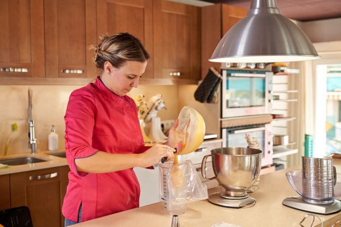 Woman filling pastry bag with whipped cream