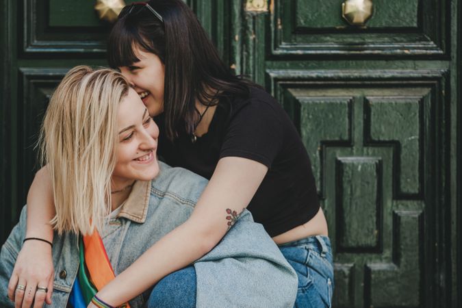 Lesbian couple sitting near door