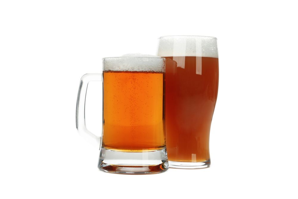 Glasses of beer isolated on light background