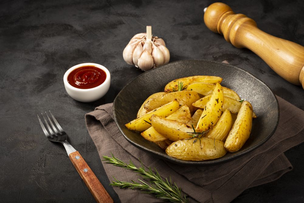 Roasted potatoes with rosemary on the plate.