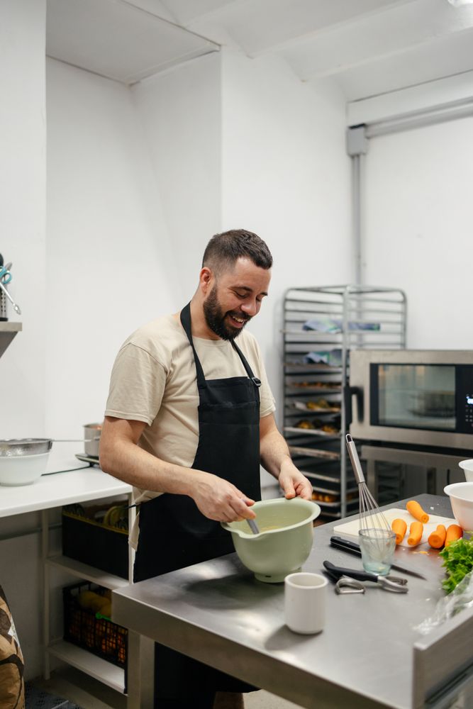 Young chef stirring with a spoon
