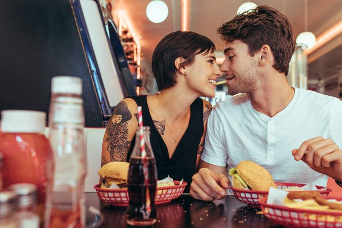 Man and woman sitting in a diner with food on the table