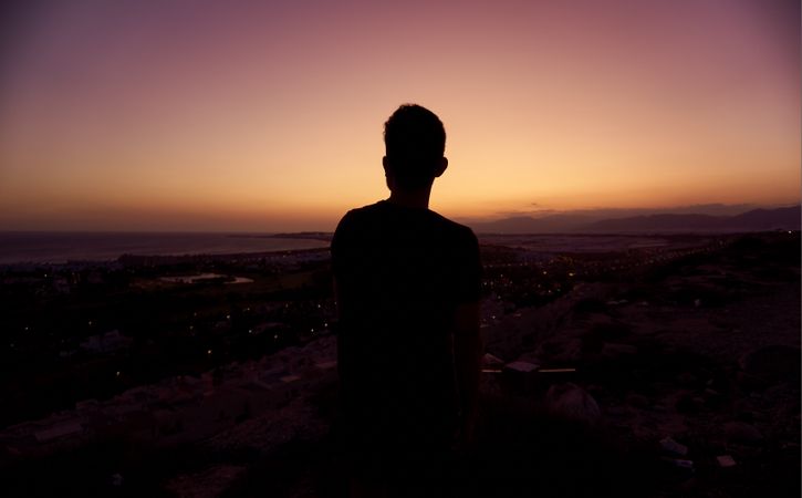 Silhouette of male enjoying picturesque sunset