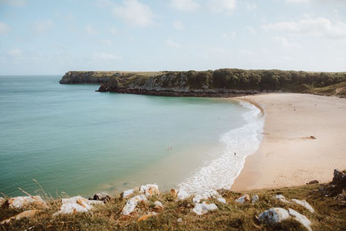 Sandy beach between long cliffs by sea