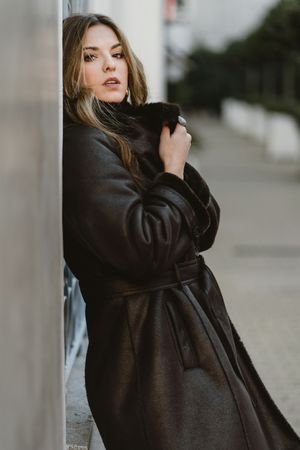 female standing on city street