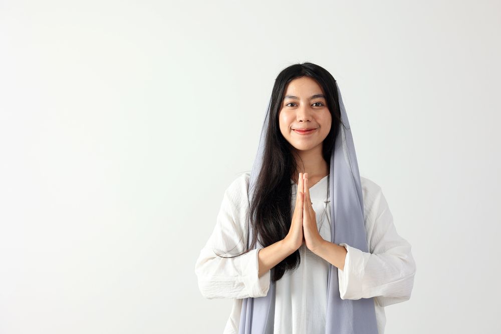 Young Indonesian Muslim Woman Wearing Hijab Scarf Gesturing Eid Mubarak Greeting