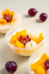 Three bowls of pudding fruit with a flower like shape from grape