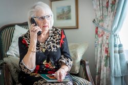 Woman taking phone call in living room