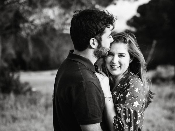 Young happy couple embracing in beautiful garden