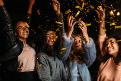 Multi-ethnic group of female friends celebrating at party on a patio