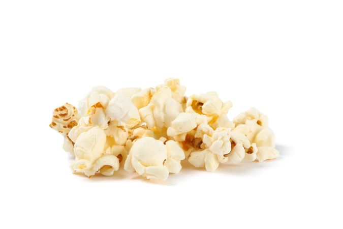 Popcorn pile isolated on blank background, close up