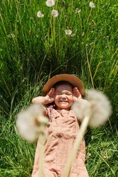 Happy little girl lying on grass
